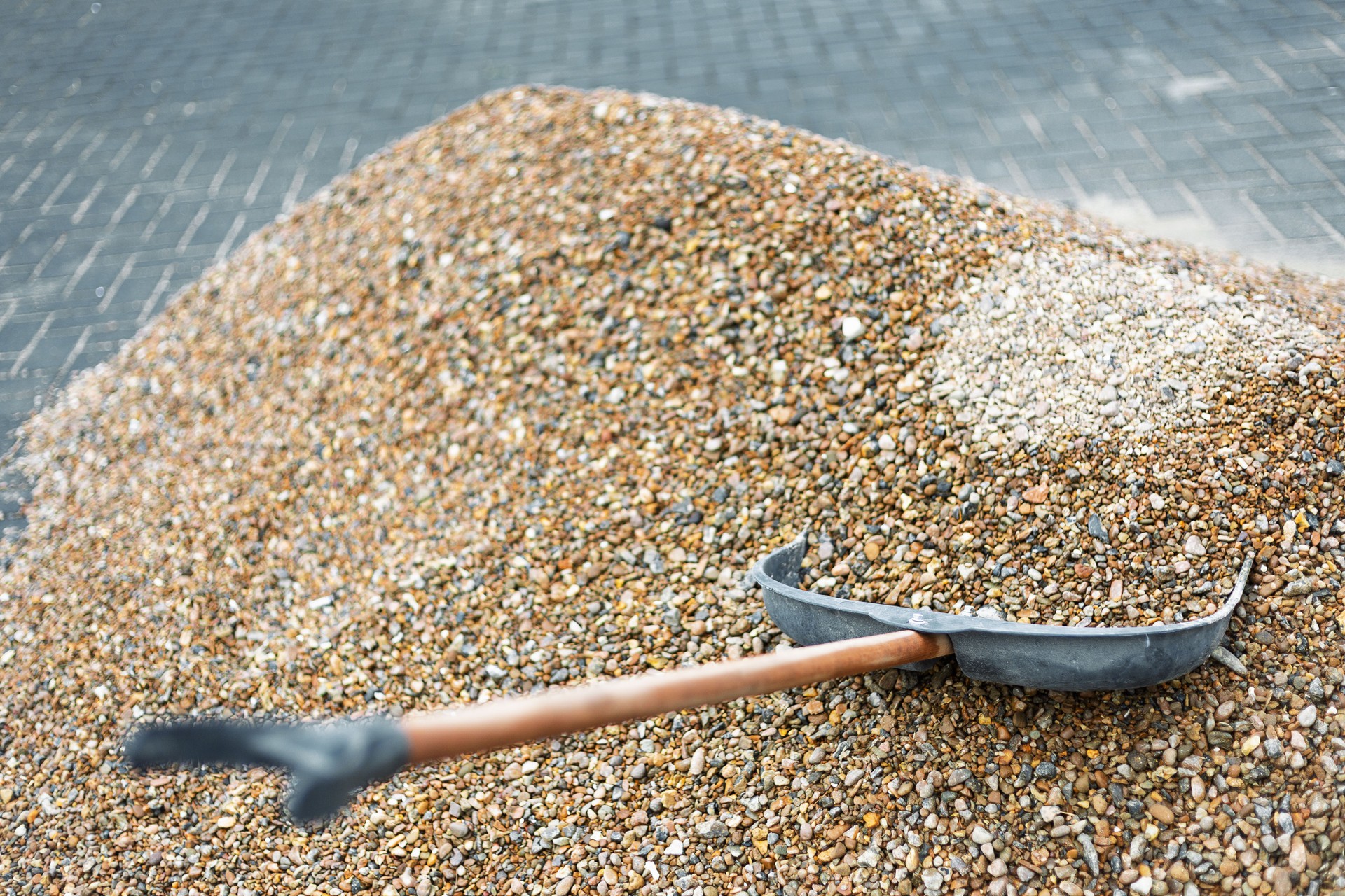 Shovel resting on a pile of gravel during roadworks